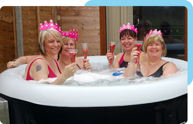 Friends enjoying drinks in a Lay-Z-Spa inflatable hot tub