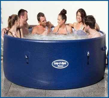 Six people relaxing in a blue Lay-Z-Spa inflatable hot tub