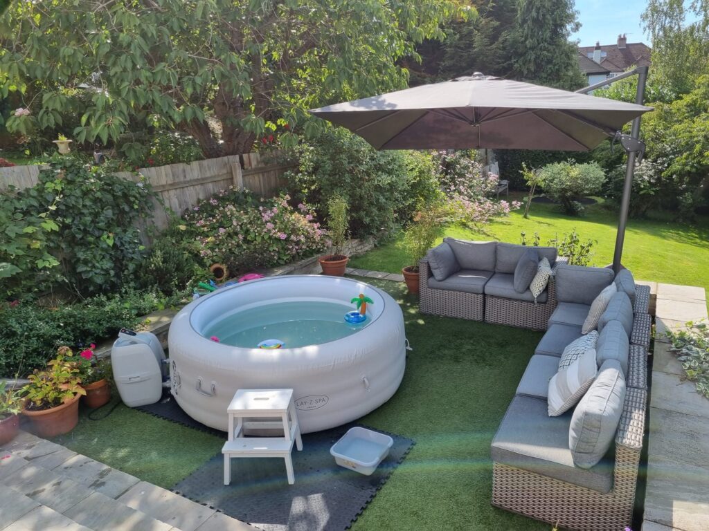 Real Lay-Z-Spa hot tub ready in a landscaped garden with seating and parasol