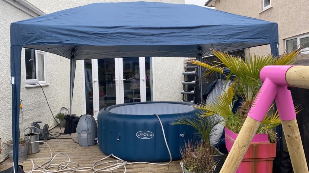 Lay-Z-Spa Milan hot tub installed on decking beneath a gazebo