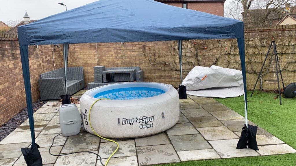 Lay-Z-Spa Vegas hot tub with pump beneath a protective gazebo
